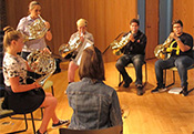 music students playing french horns for concert