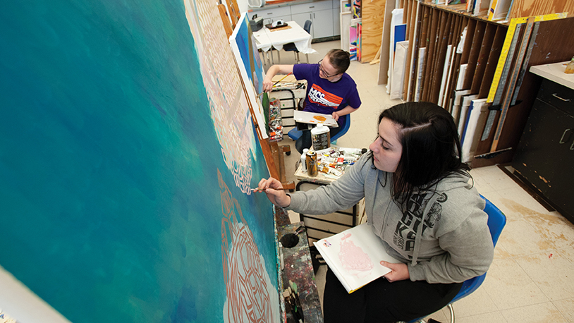 MCC student painting a picture