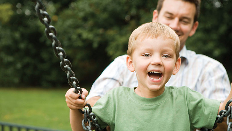 father with son on swing