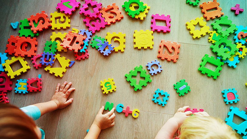 young kids learning with colorful letter tile blocks