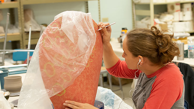 art student working on ceramics project